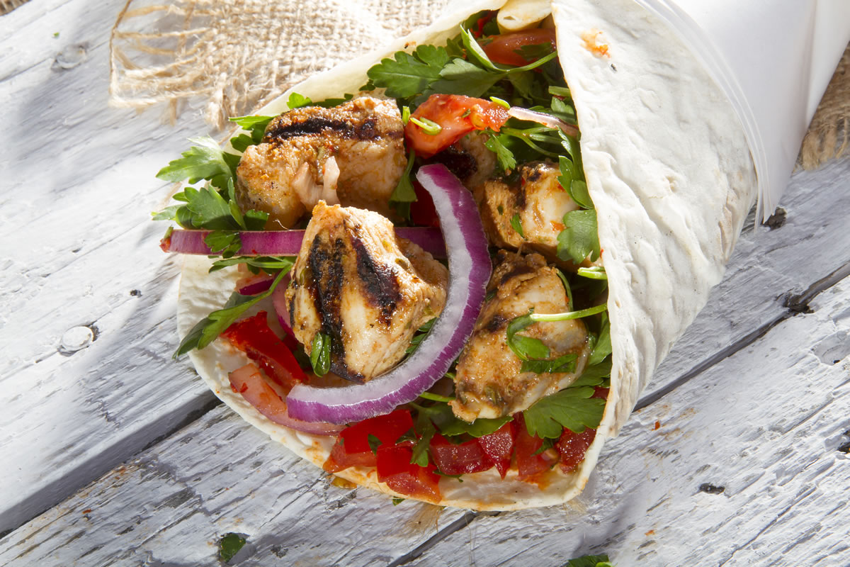 Mediterranean chicken wrap with diced chicken, parsley, tomato and red onion
