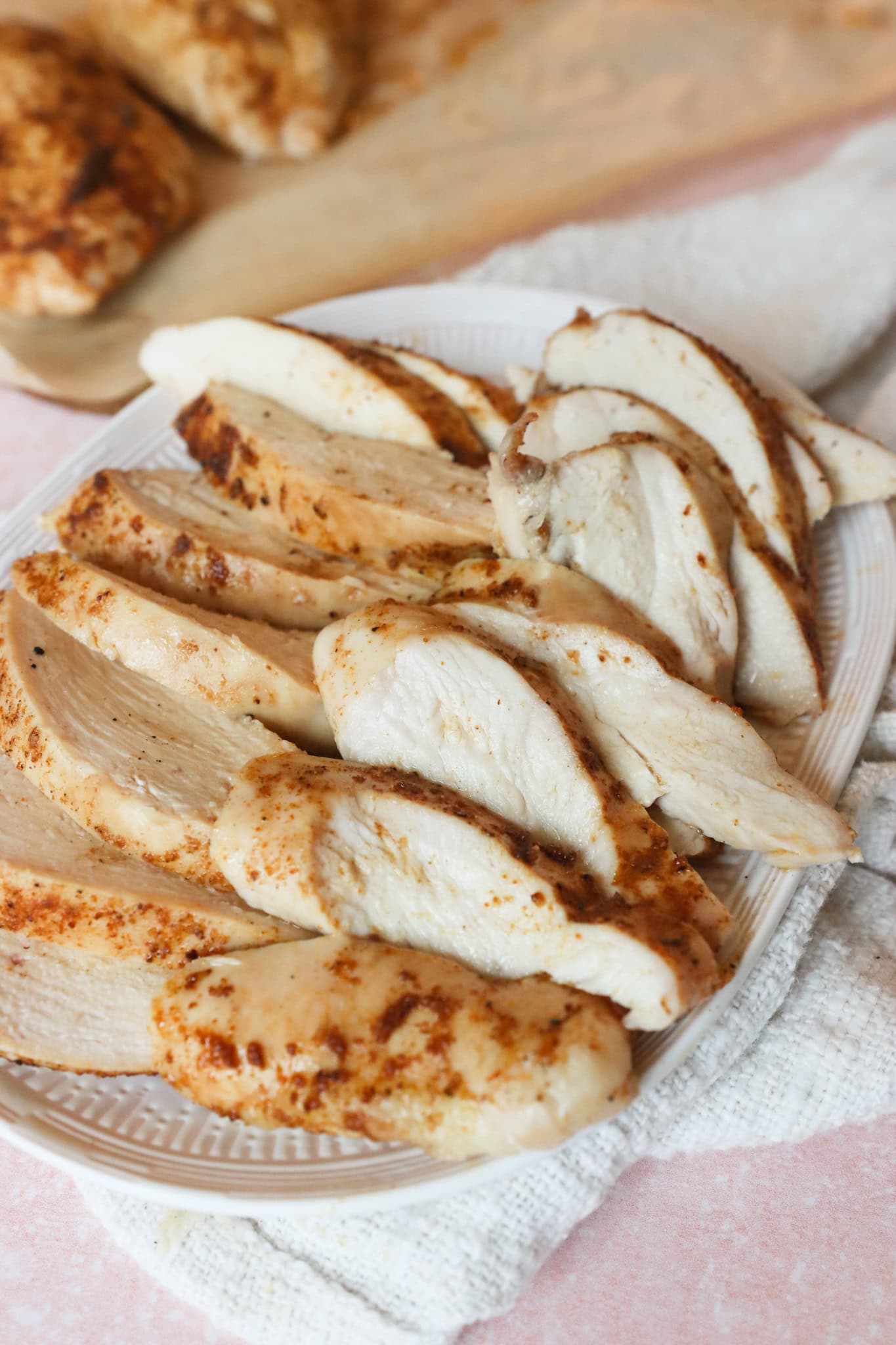 Oven roasted chicken breast cut into consistent slices
